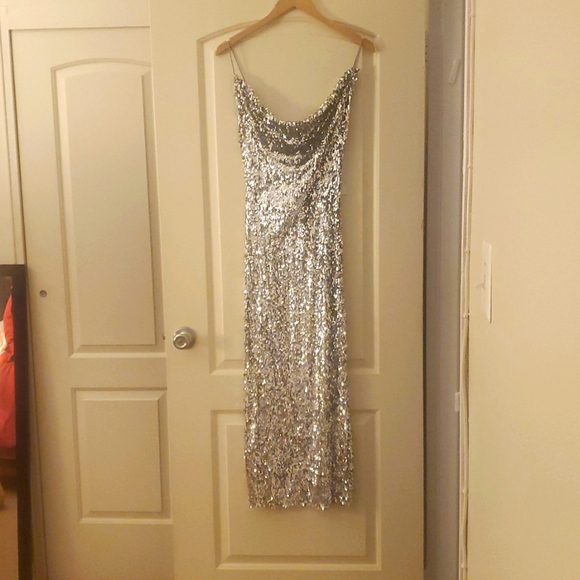 Sequin midi dress with flowy neckline and spaghetti straps.